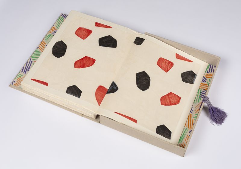 Open faced book in shallow box with graphic elements