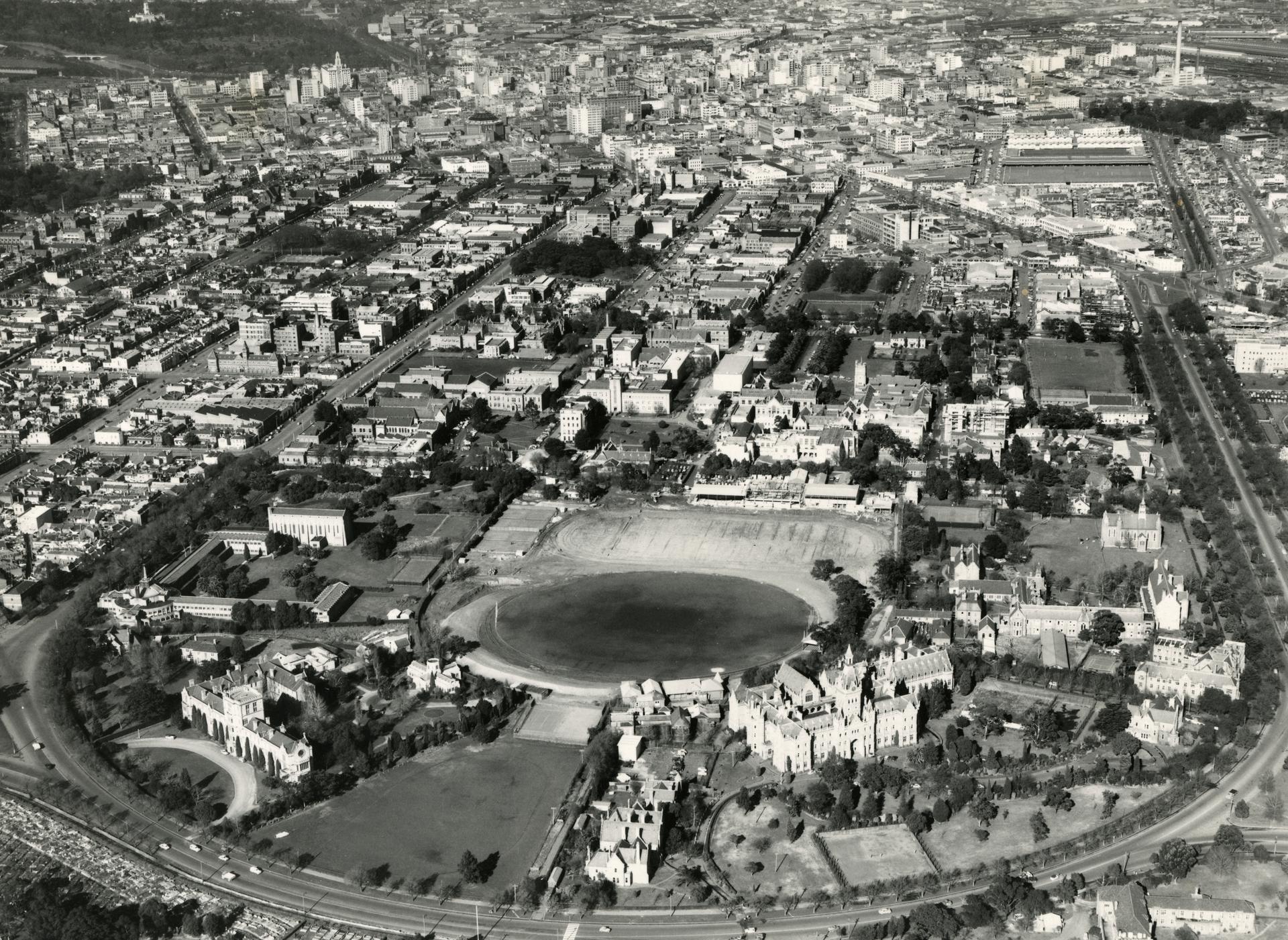 Aerial view showing beyond the main oval, c1956