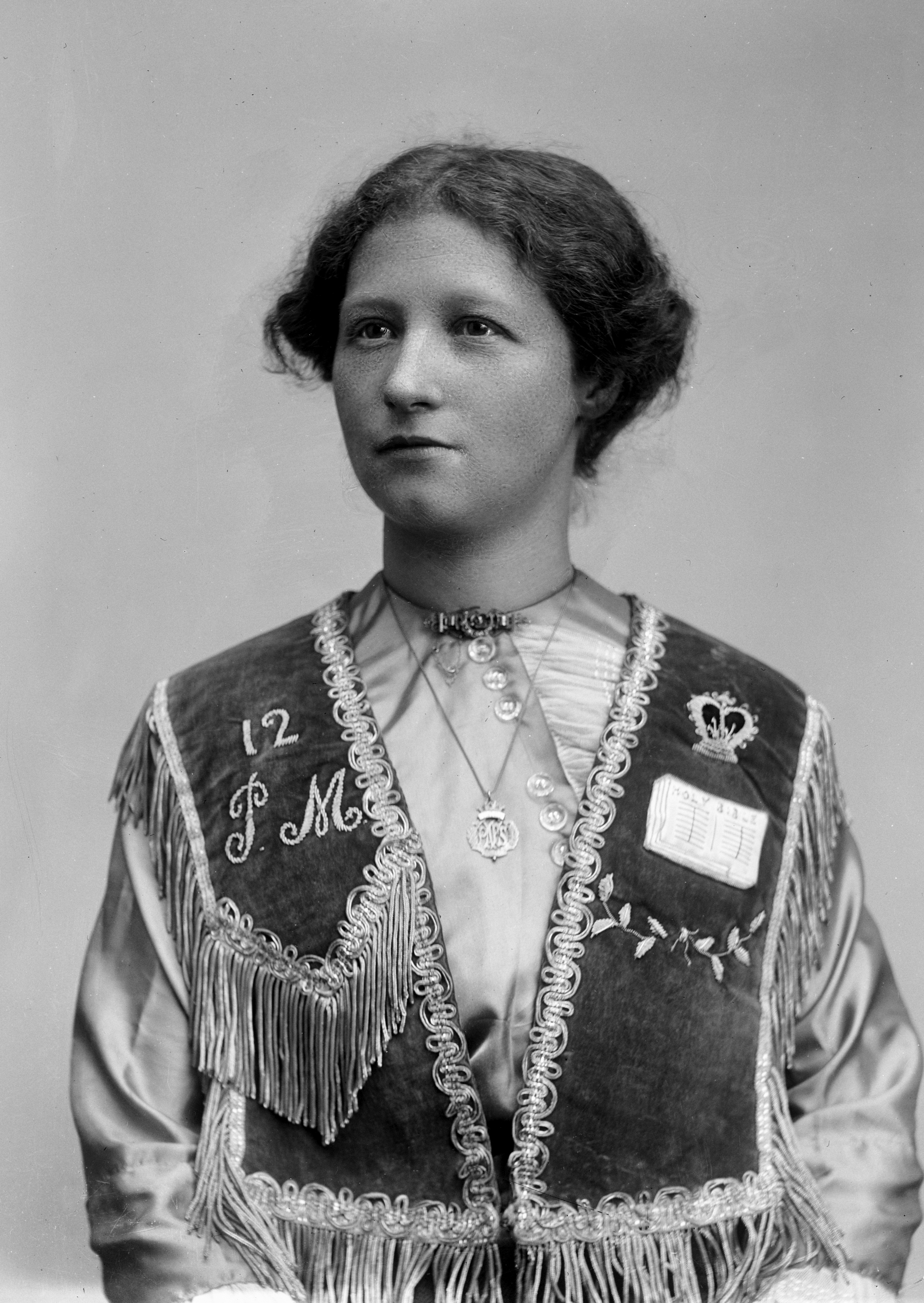 William John Howship [photographer] “Portrait of Miss McCoy wearing an embroidered vest of unknown symbolism”, 10 July 1920, Howship, W. J. Collection, 1988.0137.00275. 