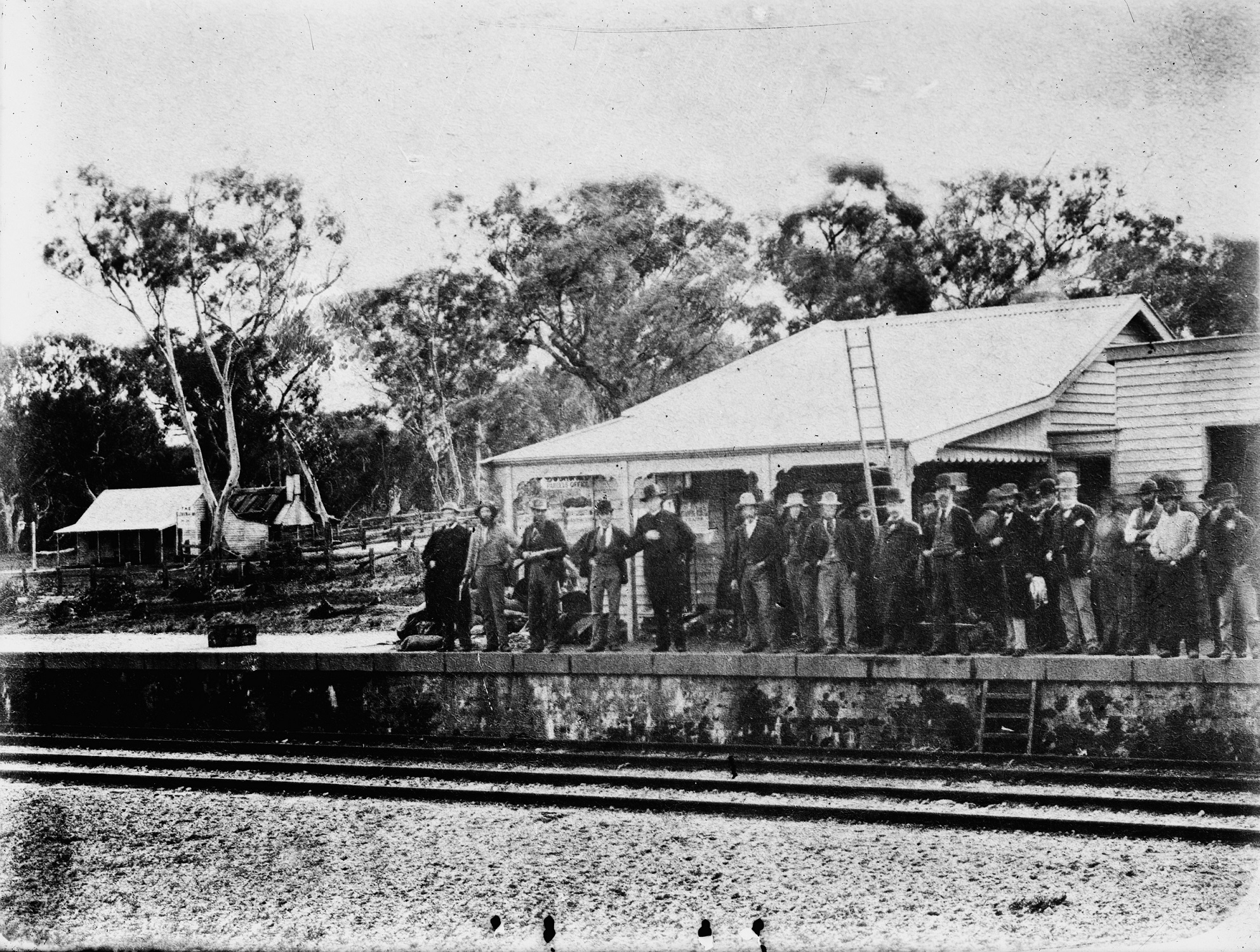 Group of men standing on Glenrowen Railway station platform