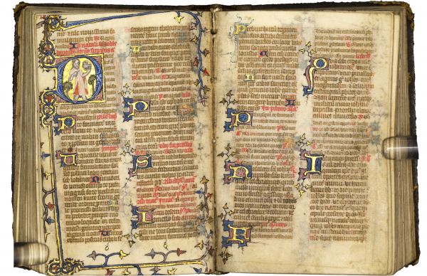 Aged book with illuminated text, spread open to two pages