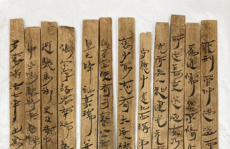 Collection of wooden slats with Chinese characters written in ink