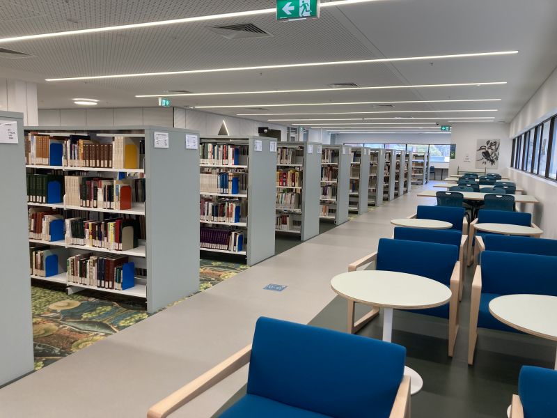 Photograph of a library with books on shelving and seating